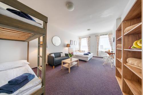 a bedroom with a bunk bed and a living room at Chata u kostela in Kořenov