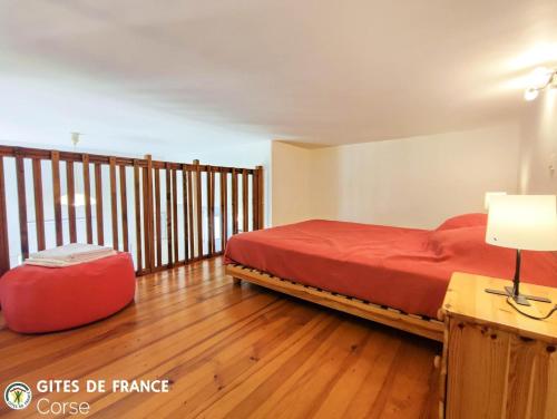 a bedroom with a bed and a red suitcase at Mezzana in Taglio-Isolaccio