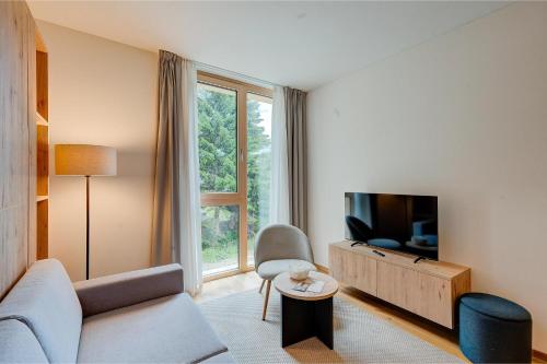 a living room with a couch and a tv at Residenza Tilia in San Bernardino
