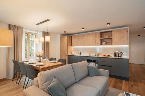a living room and kitchen with a couch and a table at Residenza Tilia in San Bernardino