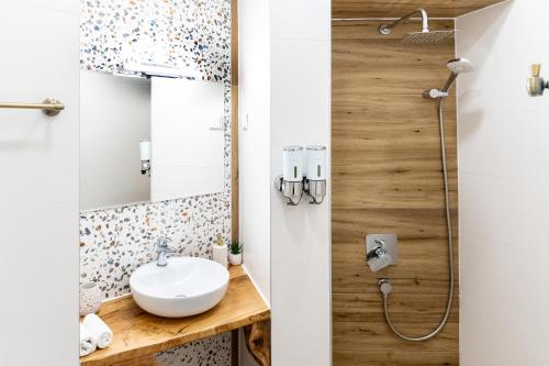 a bathroom with a sink and a shower at Corner House in Lovech