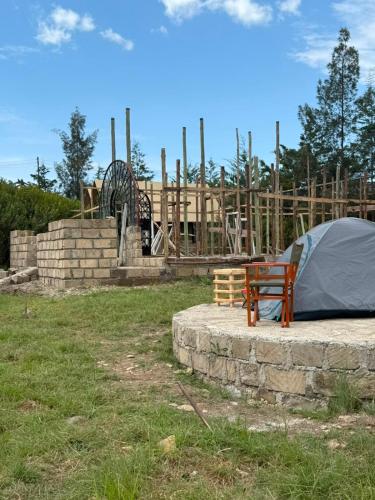 a tent and a bench next to a playground at Serenity Glamping By Rafiki in Nanyuki