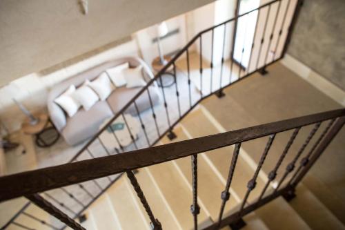 an overhead view of a staircase with chairs and a couch at Le Scuderie - Castello Monaci in Salice Salentino
