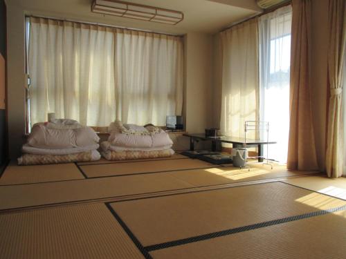 a living room with two bean bags in front of a window at Funayado Akitaya in Kamakura
