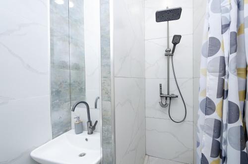 a bathroom with a shower and a sink at Garden Hostel 16 in Yerevan
