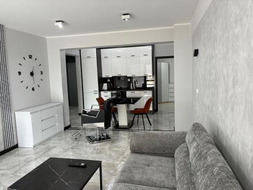 a living room with a couch and a table at Legowisko nad Legą Centrum Olecka in Olecko