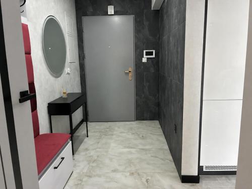 a bathroom with a white door and a mirror at Legowisko nad Legą Centrum Olecka in Olecko