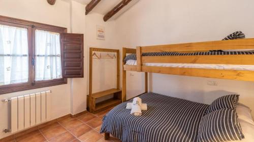 a bedroom with two bunk beds and a stuffed animal on a bed at Villa Andrea Comares in Comares