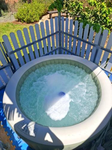 a circular plunge pool with a fence around it at Workation experience in beautiful village in Temarah
