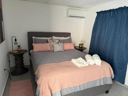 a bedroom with a bed with two towels on it at Armonia Rosada in Cabo Rojo