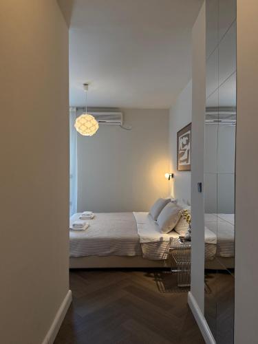 a bedroom with a bed and a mirror at Hotel Orion in Vodice