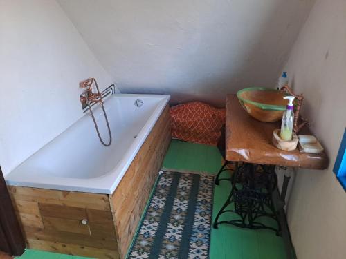 a small bathroom with a tub and a sink at Maramureș Nook in Comarnic