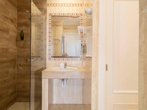 a bathroom with a sink and a mirror at Ona Village Cala d'Or in Cala d´Or