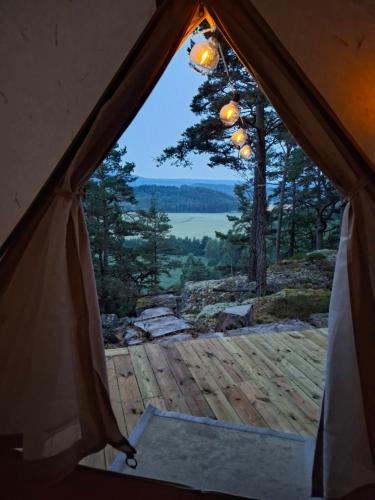 a view from inside a tent looking out at a lake at Halden Glamping in Halden