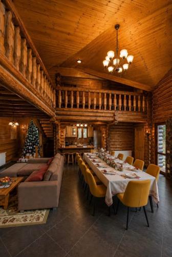 a large dining room with a long table and chairs at Rustic Cottage in Sibiu