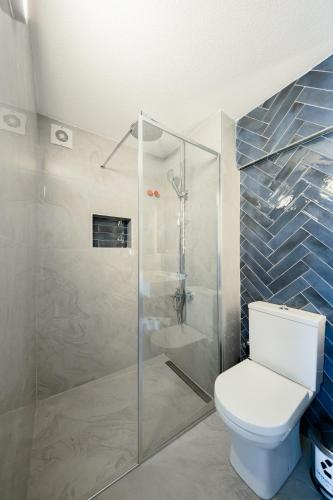 a bathroom with a toilet and a glass shower at ADAYELI BUTIK HOTEL in Karaburun