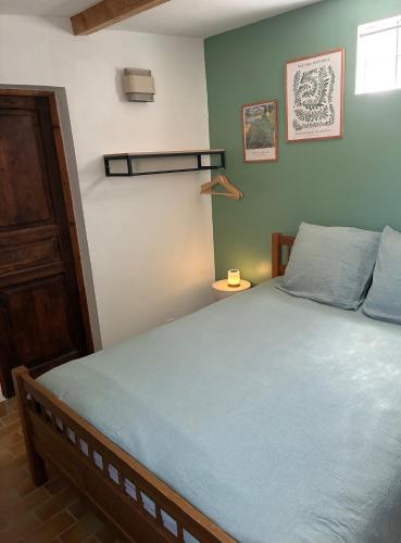 a bedroom with a large bed with blue sheets at Casa Geco in Flayosc