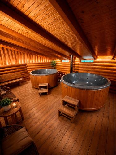 a large room with two large jacuzzi tub at Дикий Кіт in Vorokhta