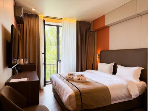 a hotel room with a bed and a balcony at Ala Boutique Hotel in Almaty