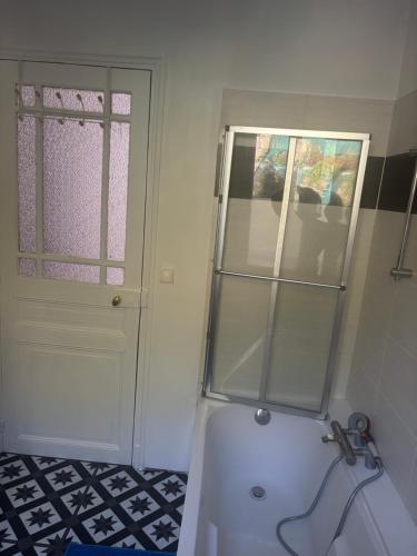 a bathroom with a shower and a white door at Cine in Sainte-Menehould