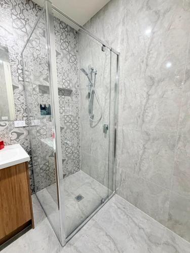 a bathroom with a shower with a glass door at Comfort Suite with Ensuite Bathroom in Wyndham Vale