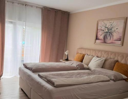 a large bed in a room with a couch at Ferienhaus Evelina in Steinheim