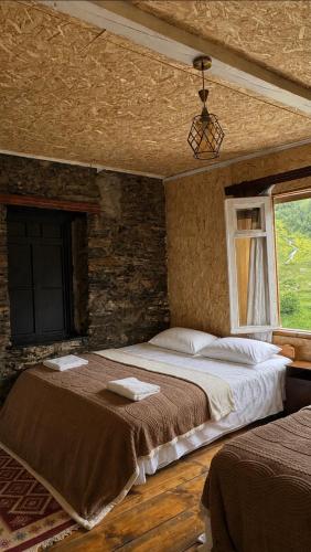 a bedroom with a large bed and a window at Ela in Ushguli