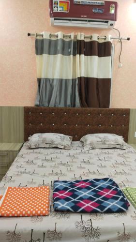 a bed with two pillows on top of it at Shravan Hotel in Rāmgarh