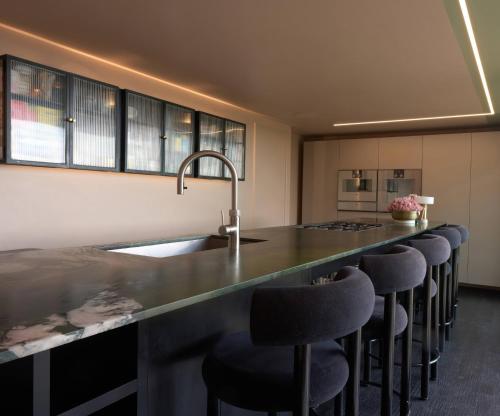 a kitchen with a counter with bar stools at Providence Cottage in Monmouth
