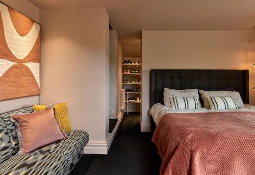 a bedroom with two beds and a couch at Providence Cottage in Monmouth