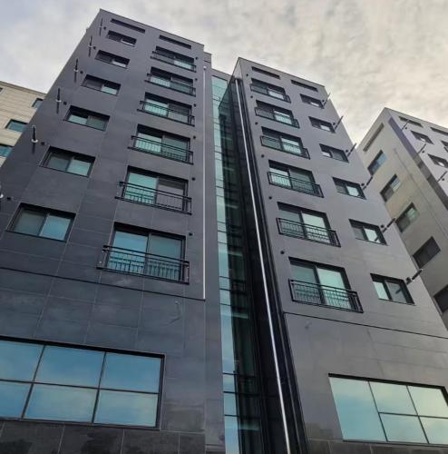 a tall building with many windows on it at Stayrium Sagajeong in Seoul