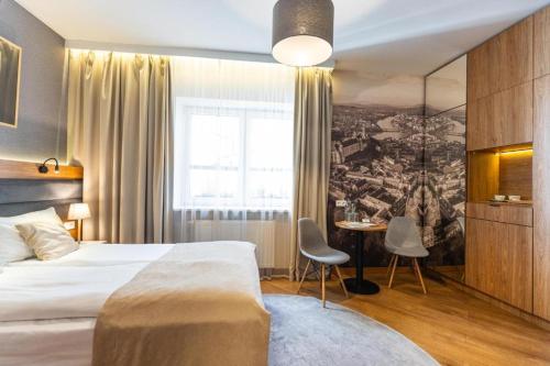 a hotel room with a bed and a table with chairs at VEGAS Motel in Kigali