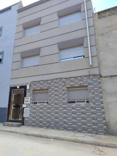 a building with windows on the side of it at Centre boukidan in Al Hoceïma