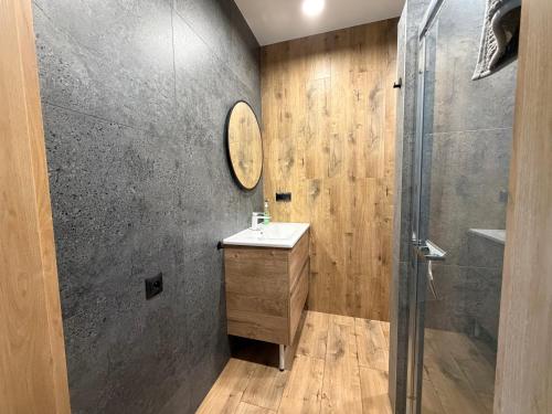 a bathroom with a sink and a shower at Via Mare in Jantar