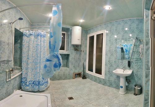 a bathroom with a shower and a toilet and a sink at Olympic Hostel in Yerevan