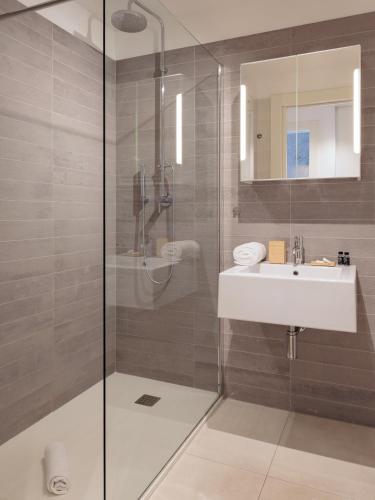 a bathroom with a shower and a sink at Portopiccolo Apartments Deluxe in Sistiana