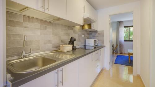 a kitchen with a sink and a microwave at NEW CASA BLU - Oasis Tamarindo 1 in Corralejo