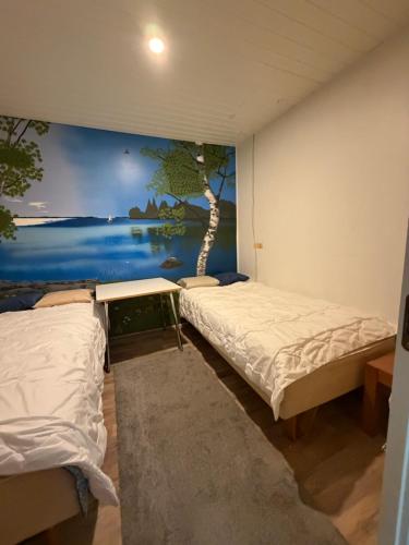 a room with two beds and a painting on the wall at Country House Marja 