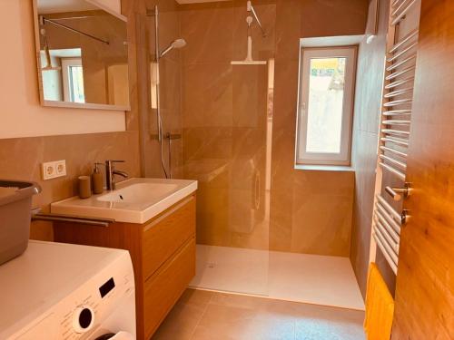 a bathroom with a sink and a shower at Ferienwohnung Mondseeblick in Tiefgraben