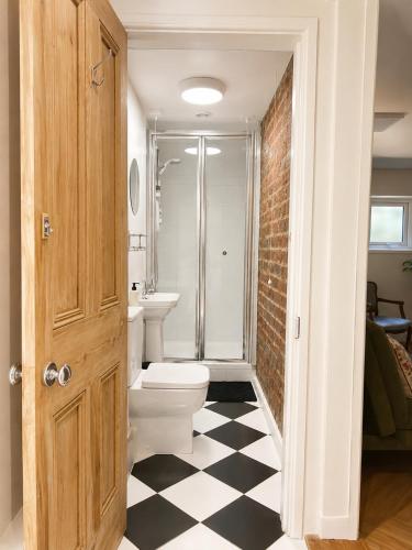 a bathroom with a toilet and a sink at Little B - Artist owned boutique apartment near Southsea beach in Portsmouth