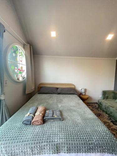 a large bed in a small room with a window at Grace Riverfront Villa Near Suvarnabhumi Airport in Lat Krabang
