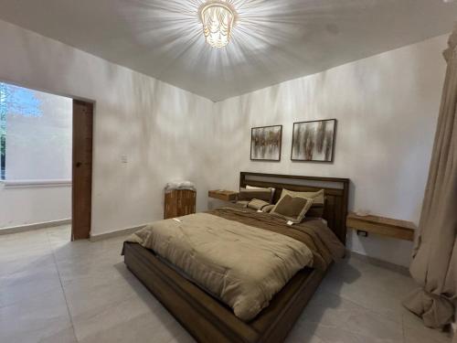 a bedroom with a large bed and a light at Villa danexia in Juan Dolio