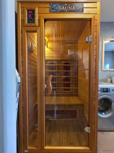 a wooden sauna with a glass door in a bathroom at Ubytovanie u Richtára in Klokoč