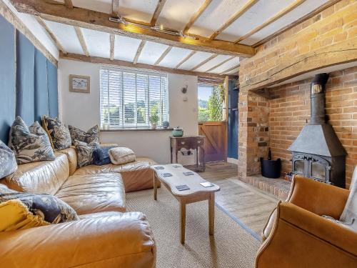 a living room with a couch and a fireplace at Pen Y Groes in Welshpool
