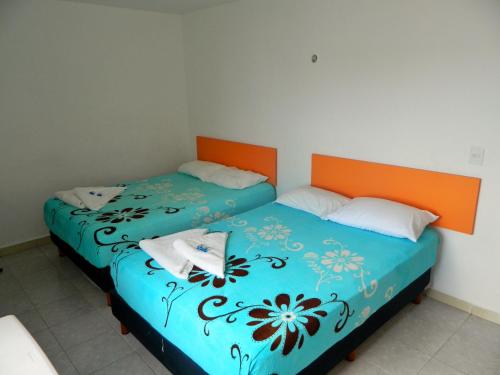 two beds sitting next to each other in a room at Casa Laurel in Cancún
