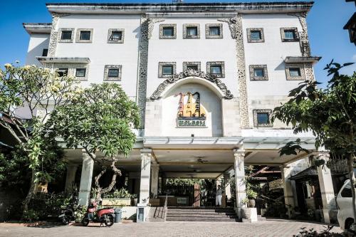 a building with a scooter parked in front of it at Melasti Kuta Beach Hotel & Spa in Kuta