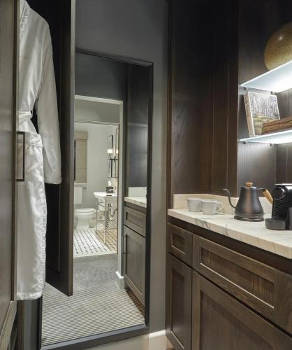 a kitchen with a mirror and a sink and a bathroom at Ojai Valley Inn in Ojai