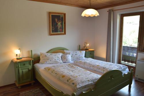 a bedroom with a bed with two night stands at Löschenbrandhof in Mittersill