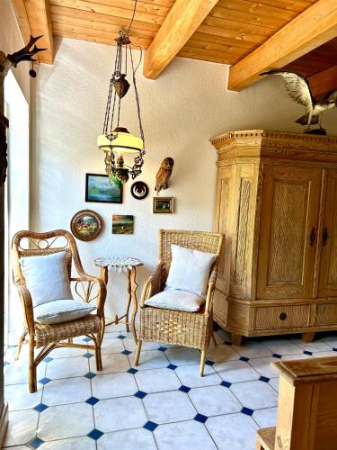 a room with two chairs and a table and a chandelier at Landhaus Hüttblek in Hüttblek