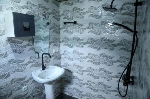 a bathroom with a sink and a shower at Guest House Mercury in Khulo
